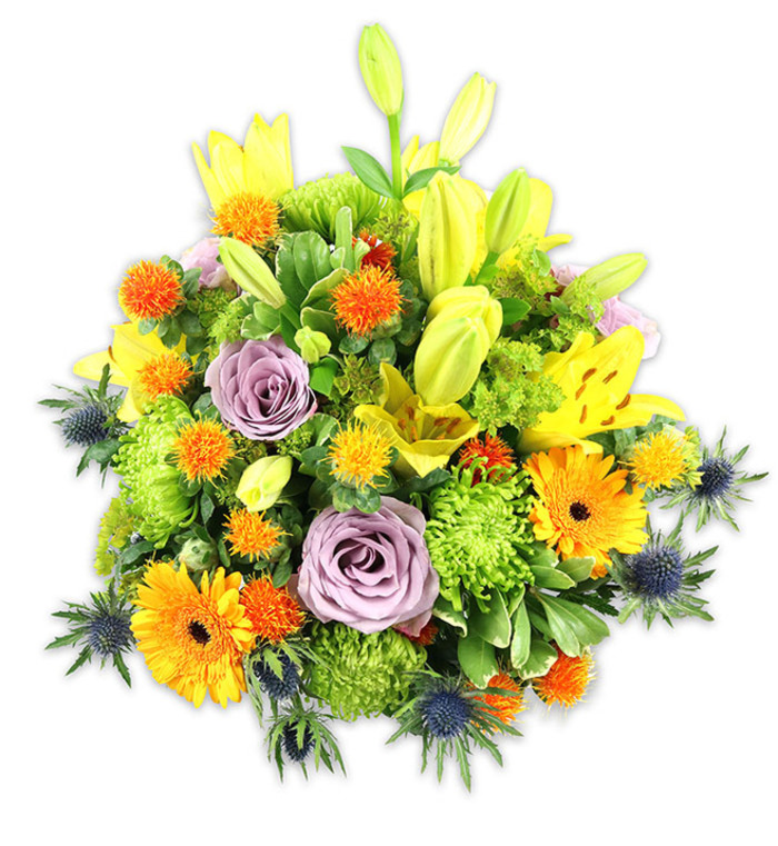 A vibrant, densely packed floral arrangement set against a plain white background reveals a considered balance of colour, form and tactile detail. Dominant yellow Asiatic lilies provide vertical emphasis-several blossoms fully open with their speckled inner petals and delicate filaments exposed, while others remain as sleek, pointed buds that suggest hope and anticipation. Two-toned lavender roses are tucked into the centre, their soft spirals creating a serene focal point among the more exuberant elements. Bright orange Gerbera daisies interrupt the texture with broad, perfectly circular heads, their dark centres lending depth. The bouquet's volume is built with lime-green button chrysanthemums whose tightly clustered florets create a cushiony, almost architectural mass. Diminutive globe-like orange and golden-yellow flowers-quirky, spiky accents-are distributed through the composition to add brightness and a playful texture. Blue-grey Eryngium thistles appear along the lower margins, their bristly, starry shapes offering a cool, contemporary counterpoint to the warm tones. Multiple kinds of foliage-broad lily leaves, glossy fill-in greens and delicate sprays-unify the arrangement and create visual pathways that guide the eye across the bouquet. Under soft, natural light the colours read true and saturated, the petals showing subtle translucence and the greens a fresh, lively tone; one can almost sense the mixture of sweet and green scents unfolding. Designed with the sensibility of an experienced local florist, this arrangement would sit beautifully on a dining table in a Bracknell home, as a welcome at a corporate reception near Easthampstead Park, or as a thoughtful gift to mark celebrations and moments of remembrance.